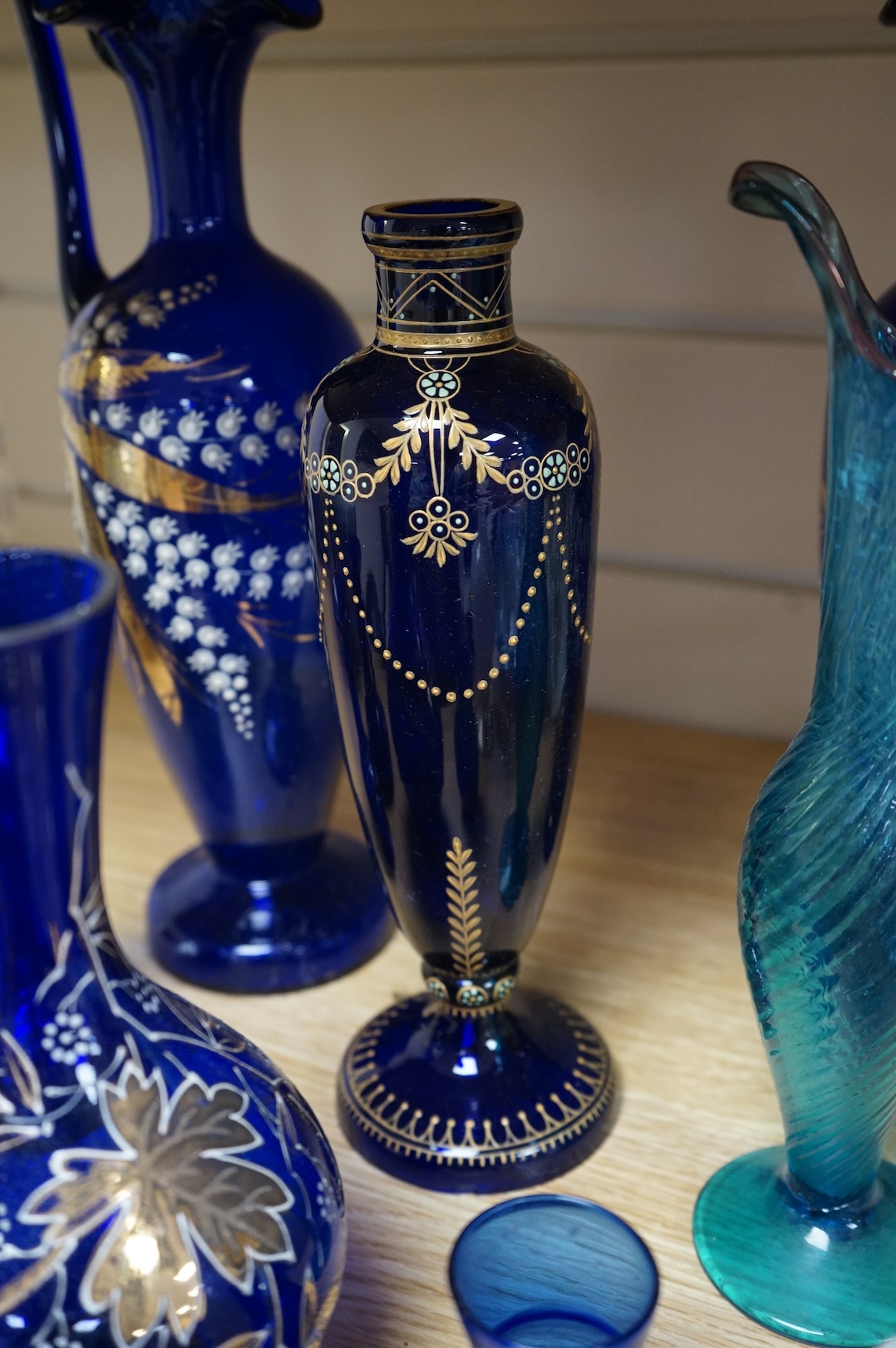 A collection of Bristol blue glassware to include enamel and gilt decanters, together with other glassware, baskets etc, largest 33cm high